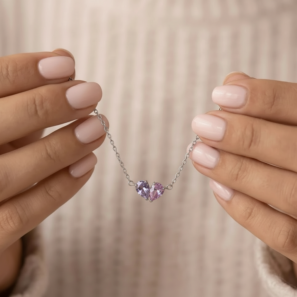 Silver Lori Bracelet held in hands, lilac and pink birthstones
