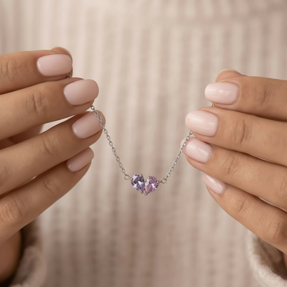 Silver Lori Bracelet held in hands, lilac and pink birthstones