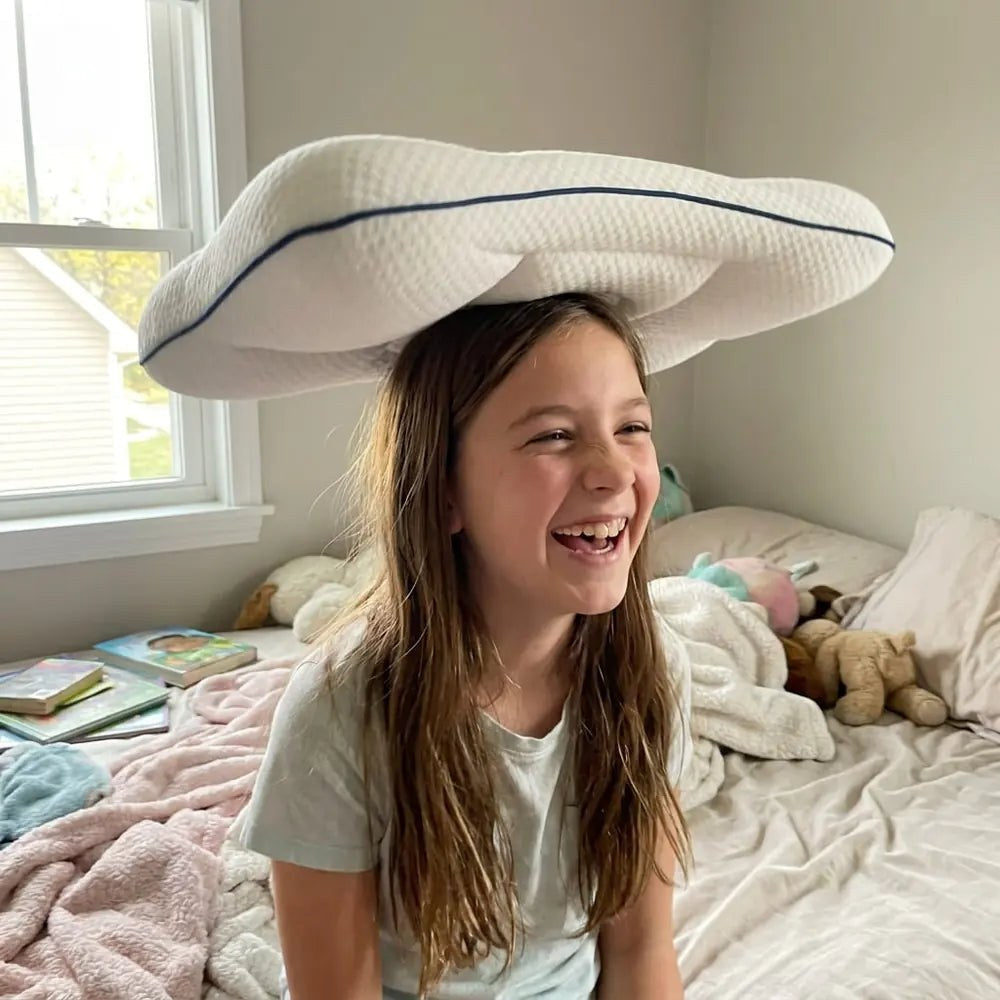 Girl playing with her neck-support pillow