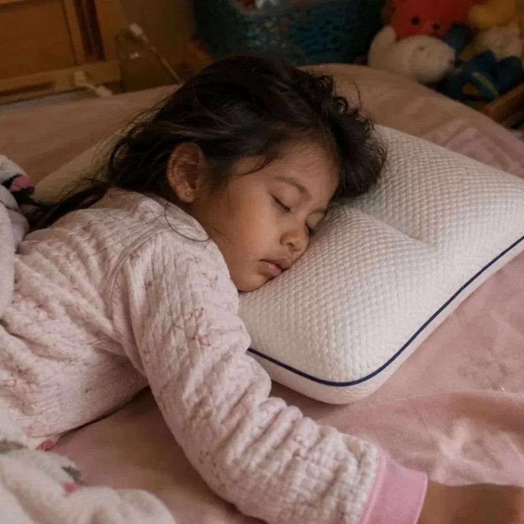 Child sleeping on her side on the pillow