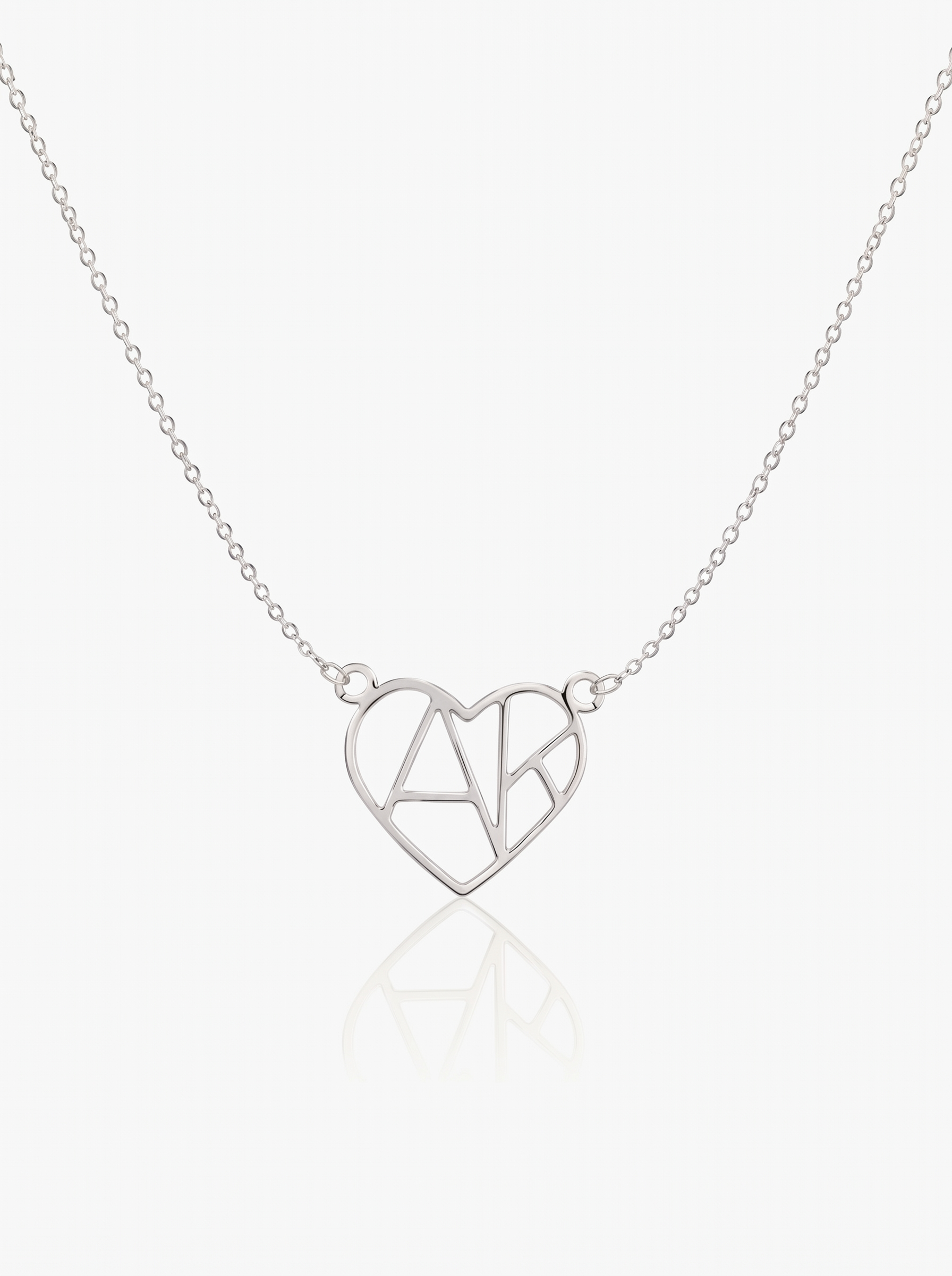 Silver heart initial necklace on white background