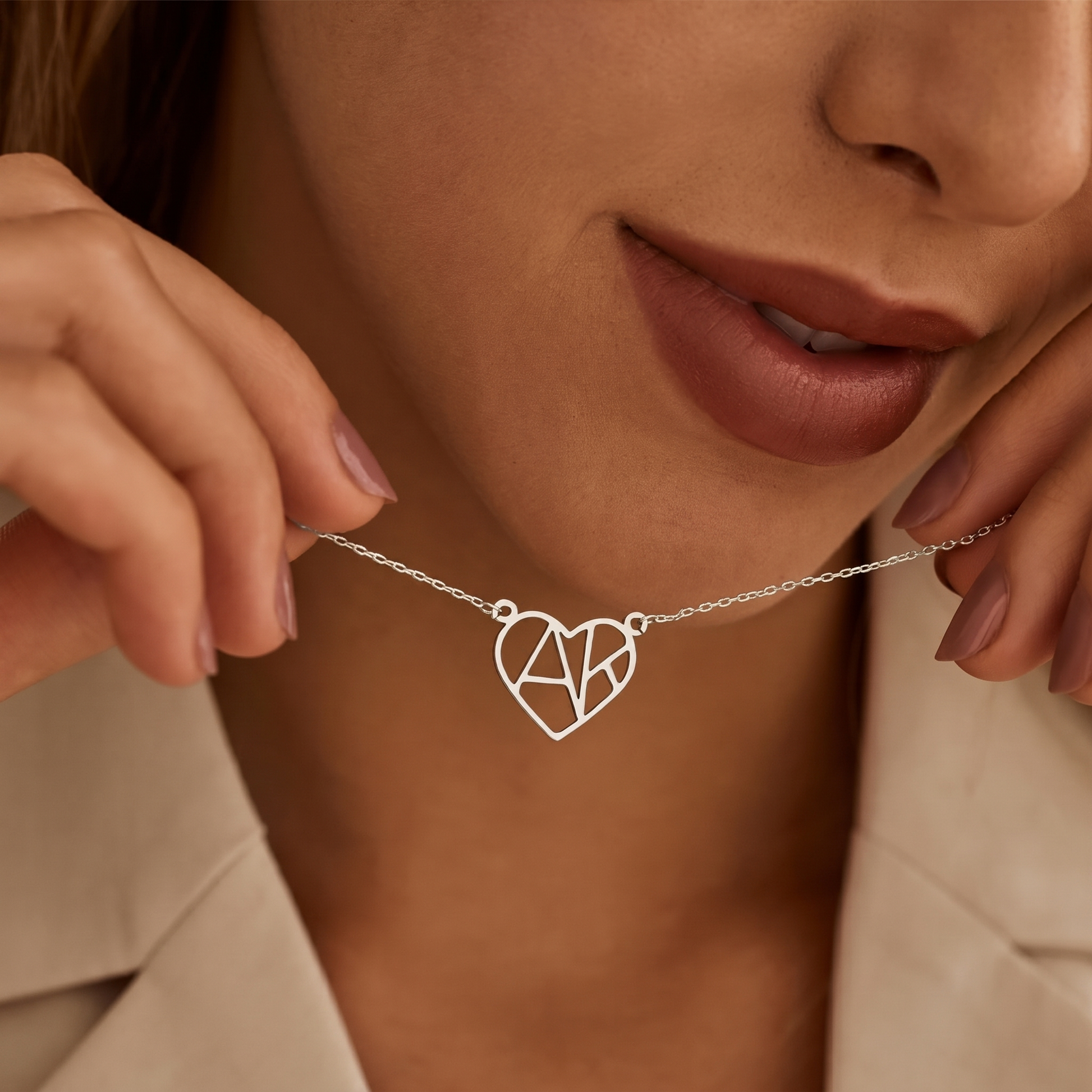 Woman wearing silver heart initial necklace