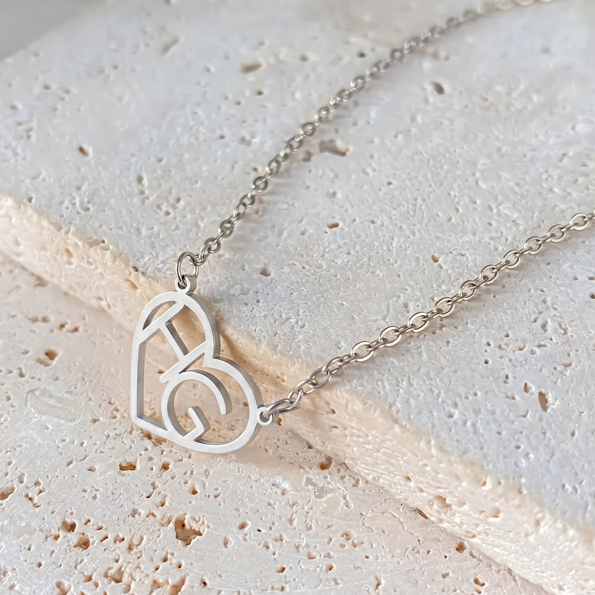 Silver heart initial necklace macro detail