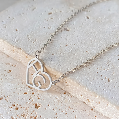 Silver heart initial necklace macro detail