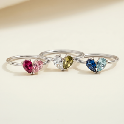 Four silver Lori birthstone rings