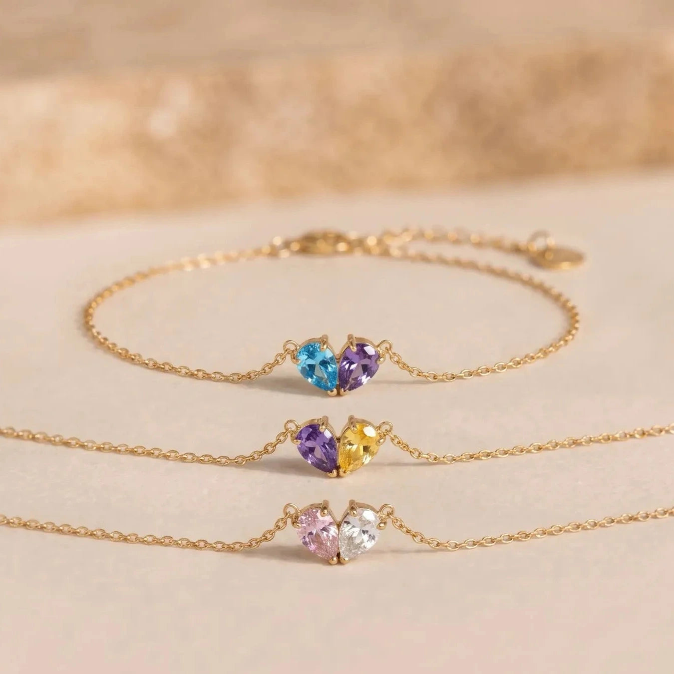 Three gold Lori Bracelets with different birthstone combinations