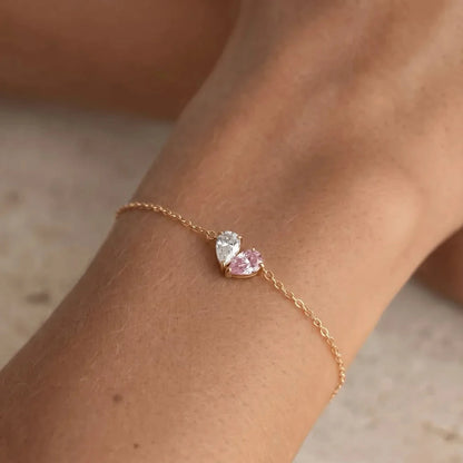 Gold Lori Bracelet worn on wrist, white and pink birthstones