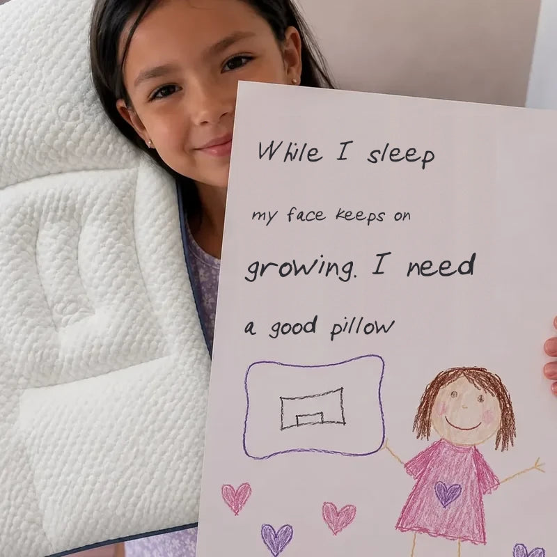 A child holding a handwritten note: “While I sleep my face keeps developing”